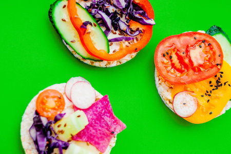 Open sandwiches of rice cakes with cream cheese , vegetables, healthy breakfastの写真素材