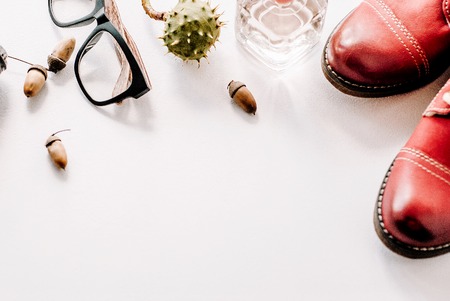Fashion leather shoes for autumn, spring. red boots on a white background lie with the camera,...