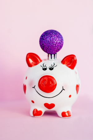 Piggy bank over pink background with christmas decoration copy space. Year of pig 2019.の写真素材