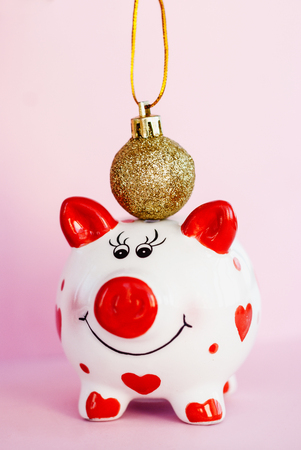 Piggy bank over pink background with christmas decoration copy space. Year of pig 2019.の写真素材