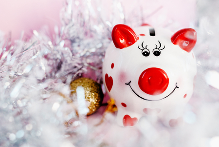 Piggy bank over pink background with christmas decoration copy space. Year of pig 2019.の写真素材