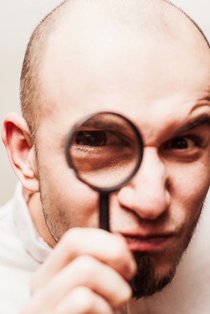 man looking through a magnifying glassの写真素材