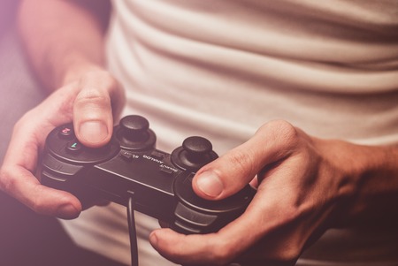 Man playing on the joystick in a game consoleの写真素材