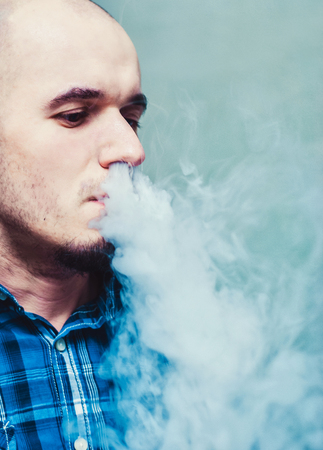 Close up of a man vaping.の写真素材