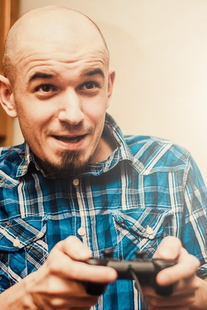 Man playing on the joystick in a game consoleの写真素材