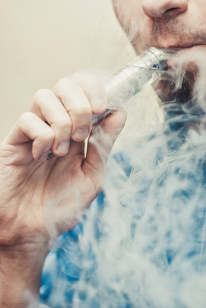 Close up of a man vaping.の写真素材