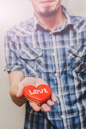 A Man holding a red heart symbolの写真素材