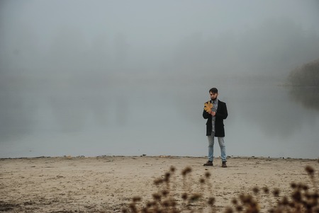 lonely man walking outsides, where full of mist in morningの写真素材