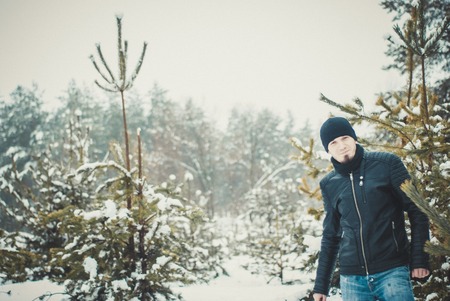Happy bearded man standing in wintertime outdoorsの写真素材