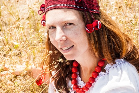 Pretty woman dressed in embroidered clothesの写真素材