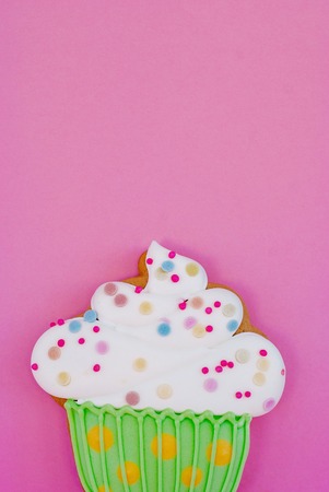Colorful cookie in cupcake shape on pink backgroundの写真素材