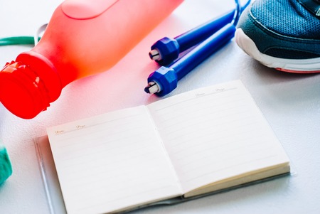 Gym stuff, blank space for exercise plan on white backgroundの写真素材