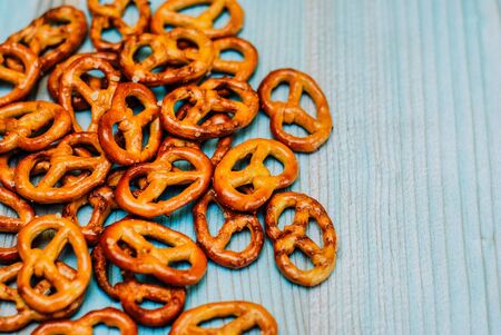 Food snack Salted crispy Pretzel on blue background with copy spaceの写真素材