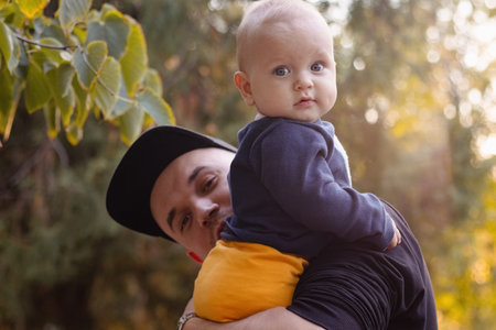 Happy father with his child outdoors.の写真素材