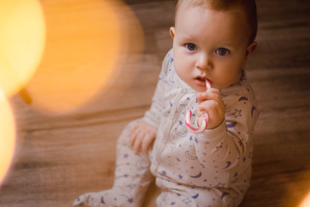 CChristmas Portrait of a beautiful little child holding a candy caneの写真素材