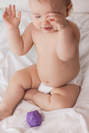 baby on a white blanket in a diaper. High quality photoの写真素材