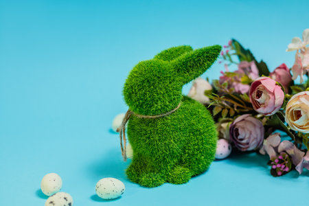 Easter bunny and eggs on blue background. Celebration layout or card.の写真素材
