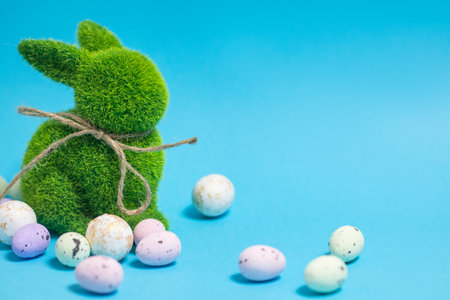 Easter bunny and eggs on blue background. Celebration layout or card.