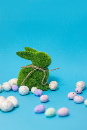 Easter bunny and eggs on blue background. Celebration layout or card.
