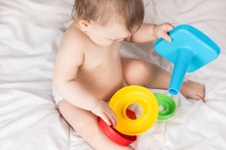 Cute baby playing with colorful rainbow toy pyramid. Toys for little kids.の写真素材