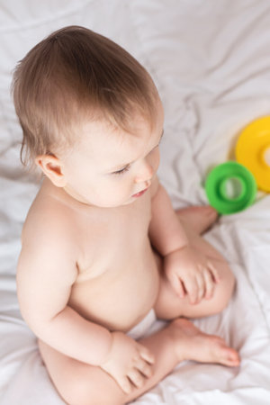 Cute baby playing with colorful rainbow toy pyramid. Toys for little kids.の写真素材