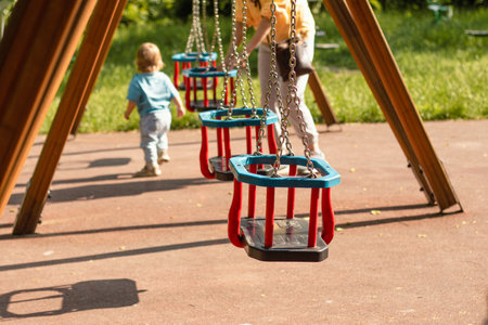 swing steel seat in playground for kid playing in outdoor parkの写真素材