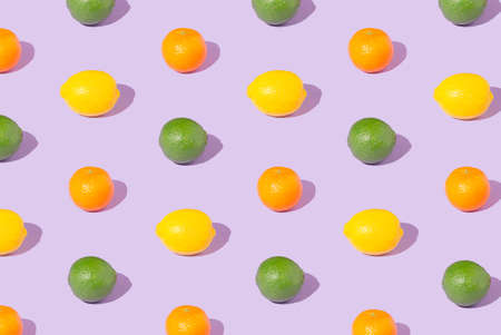 Creative pattern made of citrus juicy fruit on light plum purple background. Minimal summer concept.の写真素材