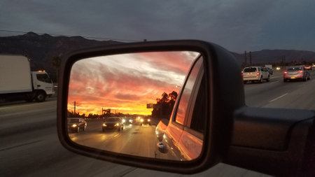 Sunset in the Rear View Mirror of a Pickup Truck on Freeway near Los Angeles