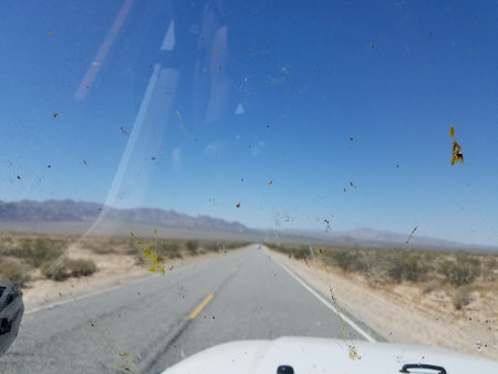 Looking Out through a Dirty Windshield on a Two Lane Desert Highwayの写真素材