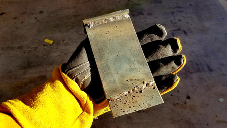 Gloved Hand Holding Welded Metal Plates, Learning to Weldの写真素材