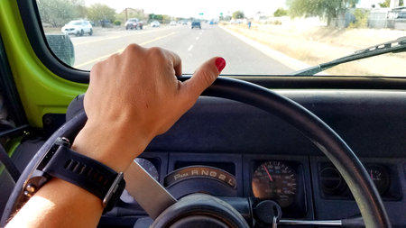 Female Left Hand on Steering Wheel, Driving a 1990s 4x4 Vehicle