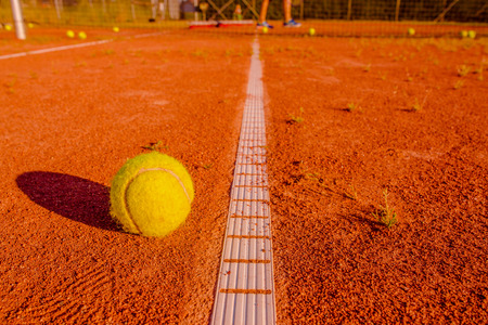 Tennis training session with a ball at the lineの写真素材