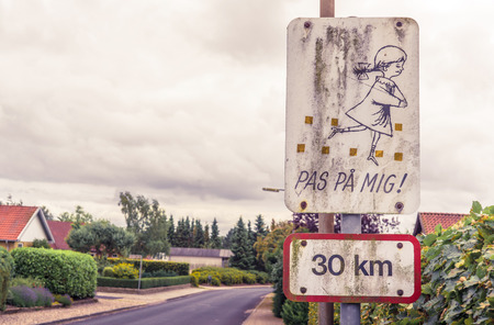 Danish sign with playing kids on a streetの写真素材