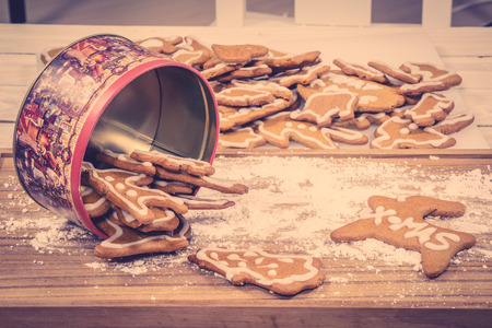 Xmas cookies in a cake tin on a kitchen table