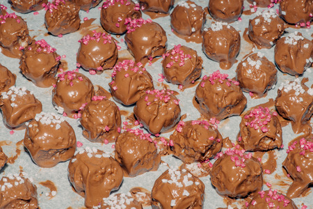 Homemade chocolate confectionary with sugar on a piece of paper