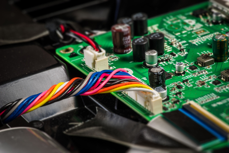 Wires in various colors on a motherboardの写真素材