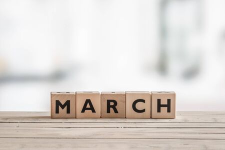 Wooden cubes with the word march on a desk