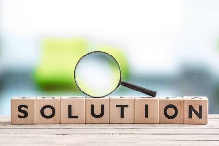Solution search sign with wooden cubes on a tableの写真素材