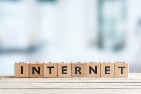 Internet sign on a bright table on blue backgroundの写真素材