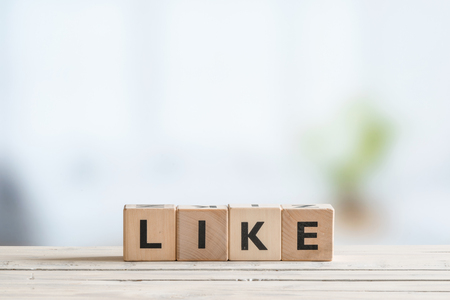 Like message made of cubes on a wooden deskの写真素材