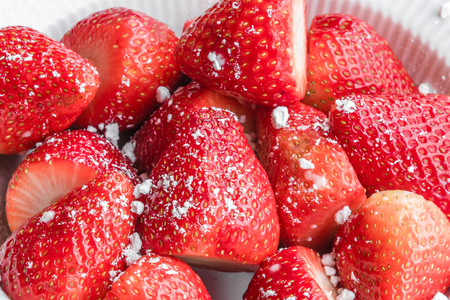 Fresh red strawberries with sugar in a bowlの写真素材
