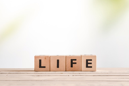 Life sign made of wooden blocks on a deskの写真素材