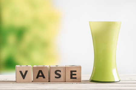 Wooden sign with the word vase on a tableの写真素材