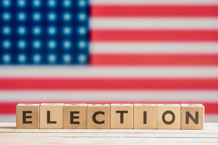 Election sign on a table with the american flagの写真素材