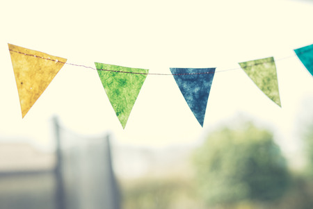 Colorful birthday flags in a garden in the spring