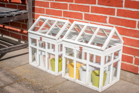 Small outdoors greenhouse in white colors at a terasseの写真素材