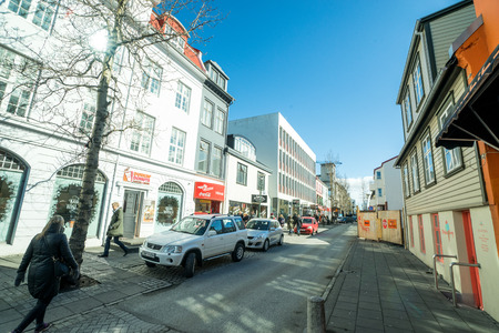 REYKJAVIK, ICELAND - APRIL 9 - 2016: Street in Reykjavik with cars and shopsのeditorial素材