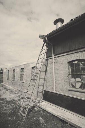 Ladder at an old weathered barn in black and white colorsの写真素材
