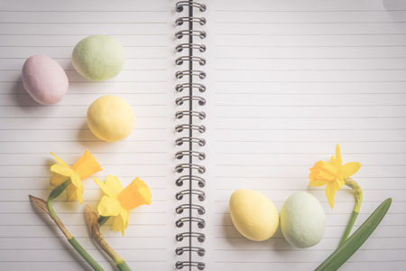 Daffodils and easter egg decoration on linear paperの写真素材