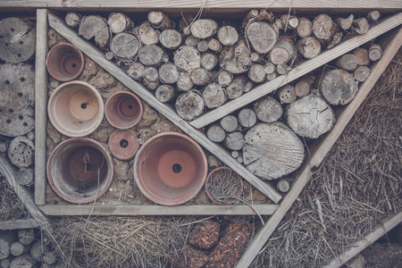 Wood on a shelf in a woodshed with pots and hayの写真素材